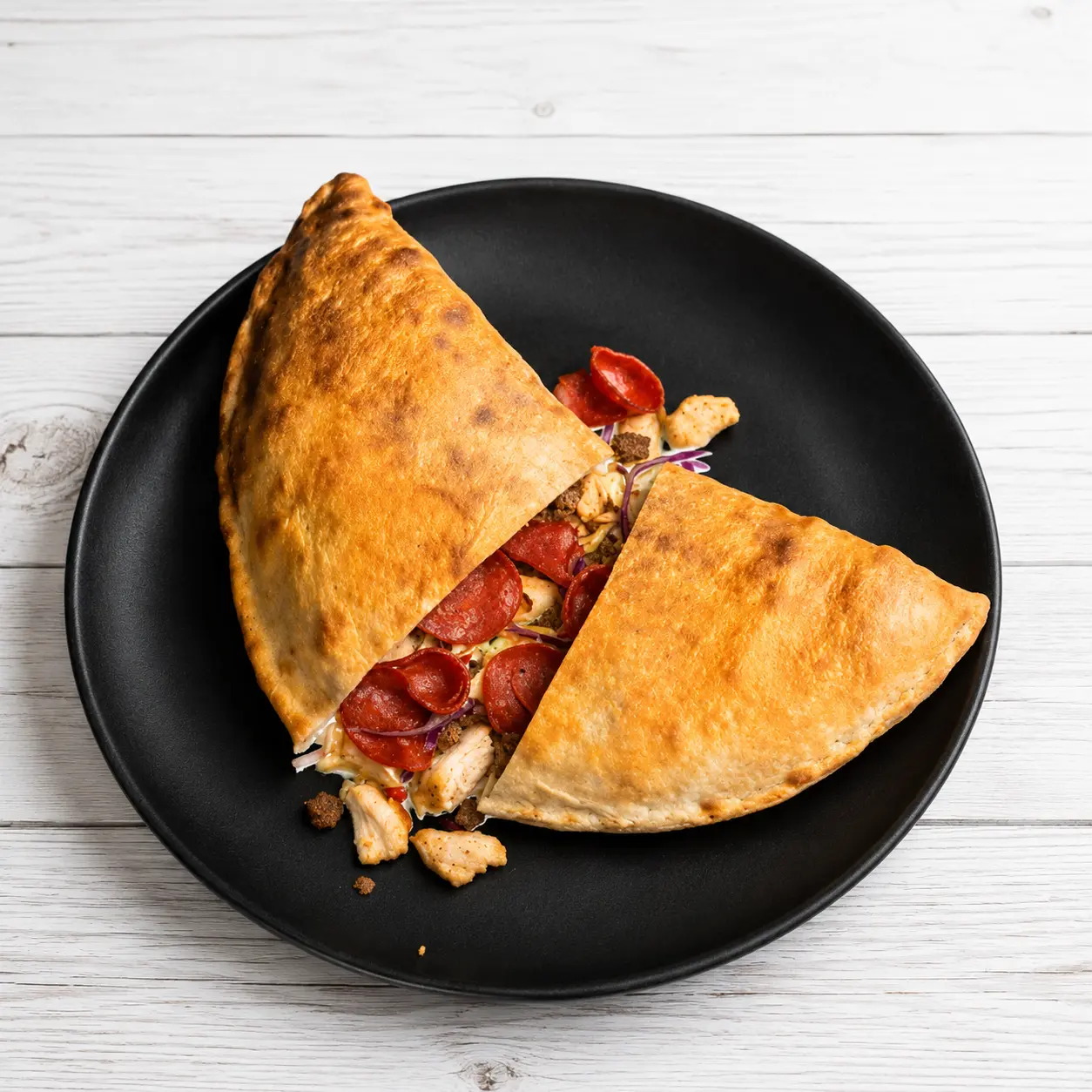 Pizza, chicken wings and dipping sauce served at Calzone Express in southwest Calgary, AB